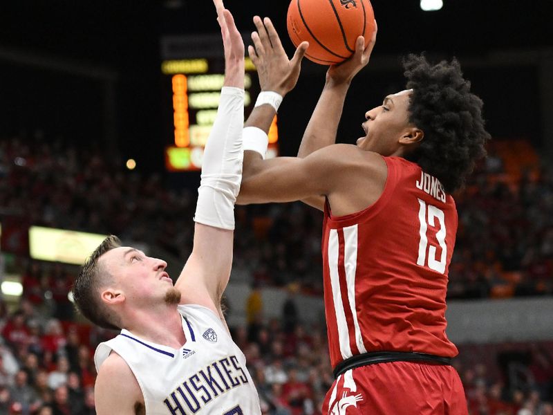 Mar 7, 2024; Pullman, Washington, USA; Washington State Cougars forward Isaac Jones(13) right shoots the ball against Washington Huskies forward Moses Wood (13) in the first half at Friel Court at Beasley Coliseum. Mandatory Credit: James Snook-USA TODAY Sports