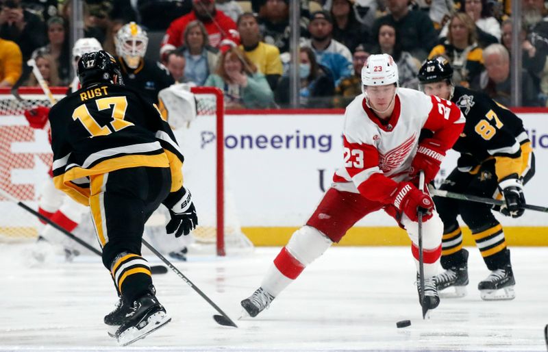 Apr 11, 2024; Pittsburgh, Pennsylvania, USA; Detroit Red Wings left wing Lucas Raymond (23) moves the puck against the Pittsburgh Penguins during the first period /at PPG Paints Arena. Mandatory Credit: Charles LeClaire-USA TODAY Sports