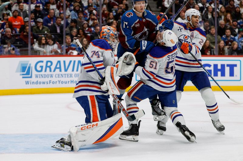 Jan 16, 2025; Denver, Colorado, USA; Edmonton Oilers goaltender Stuart Skinner (74) makes a save as Colorado Avalanche center Parker Kelly (17) collides with defenseman Troy Stecher (51) as  at Ball Arena. Mandatory Credit: Isaiah J. Downing-Imagn Images