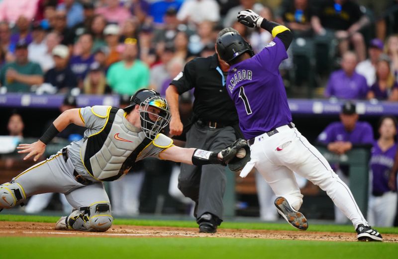 Jun 14, 2024; Denver, Colorado, USA; Pittsburgh Pirates catcher Henry Davis (32) tags out Colorado Rockies second base Adael Amador (1) in the sixth inning at Coors Field. Mandatory Credit: Ron Chenoy-USA TODAY Sports