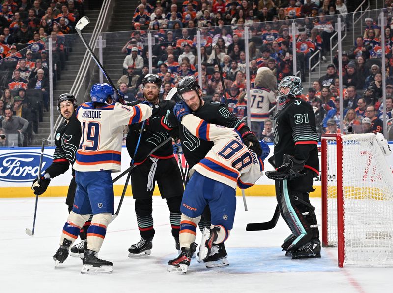 Dec 4, 2025; Edmonton, Alberta, CAN; Edmonton Oilers center Adam Henrique (19 ) and Oilers left winger Andrew Mangiapane (88) battle with Seattle Kraken defenseman Adam Larsson (6) and Kraken defenseman Ryan Lindgren (55) in front of Seattle Kraken goalie Phillip Grubauer (31) during the third period at Rogers Place. Mandatory Credit: Walter Tychnowicz-Imagn Images