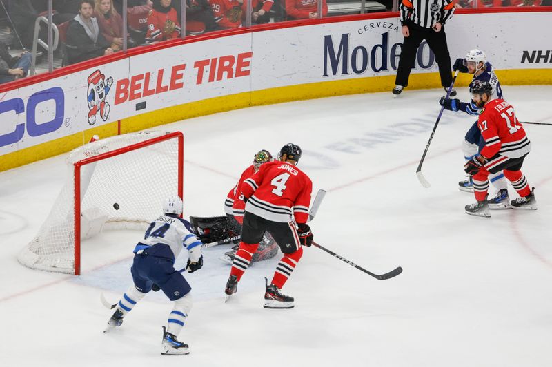 Feb 23, 2024; Chicago, Illinois, USA; Winnipeg Jets left wing Kyle Connor (81) scores a game winning goal against the Chicago Blackhawks during overtime at United Center. Mandatory Credit: Kamil Krzaczynski-USA TODAY Sports