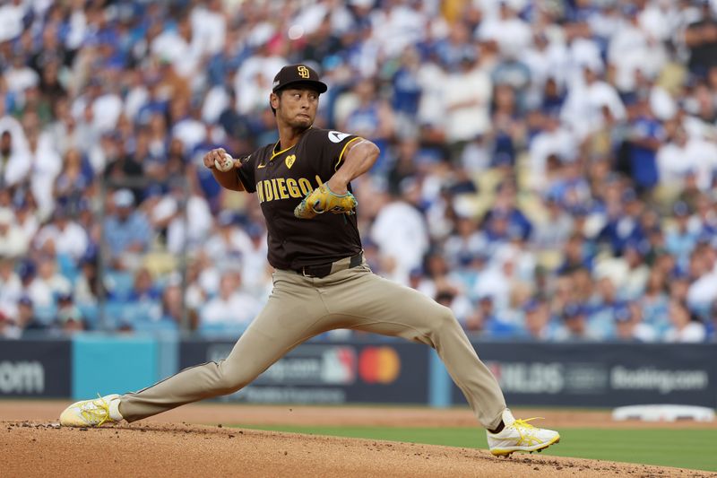 Oct 11, 2024; Los Angeles, California, USA; San Diego Padres pitcher Yu Darvish (11) pitches against the Los Angeles Dodgers in the first inning during game five of the NLDS for the 2024 MLB Playoffs at Dodger Stadium. Mandatory Credit: Kiyoshi Mio-Imagn Images