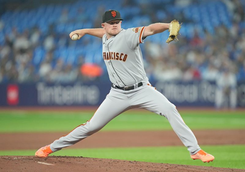 Jun 28, 2023; Toronto, Ontario, CAN; San Francisco Giants starting pitcher Logan Webb (62) throws a pitch against the Toronto Blue Jays during the first inning at Rogers Centre. Mandatory Credit: Nick Turchiaro-USA TODAY Sports