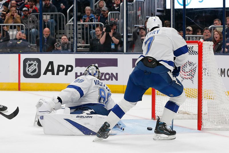 Feb 10, 2024; Columbus, Ohio, USA; Tampa Bay Lightning defenseman Haydn Fleury (7) clears the loose puck of a Andrei Vasilevskiy (88) save against the Columbus Blue Jackets during the second period at Nationwide Arena. Mandatory Credit: Russell LaBounty-USA TODAY Sports