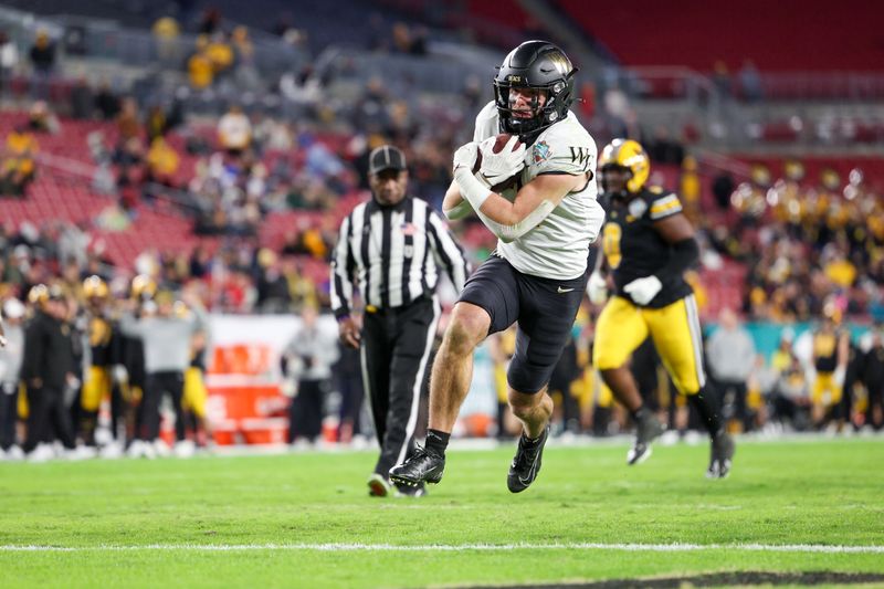 Dec 23, 2022; Tampa, Florida, USA; Wake Forest Demon Deacons wide receiver Taylor Morin (2) scores a touchdown against the Missouri Tigers in the fourth quarter in the 2022 Gasparilla Bowl at Raymond James Stadium. Mandatory Credit: Nathan Ray Seebeck-USA TODAY Sports