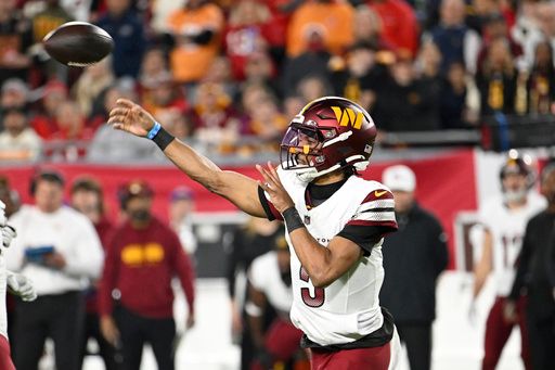 Washington Commanders quarterback Jayden Daniels passes against the Tampa Bay Buccaneers during the first half of an NFL wild-card playoff football game in Tampa, Fla., Sunday, Jan. 12, 2025. (AP Photo/Jason Behnken)