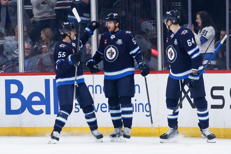 Mar 3, 2026; Winnipeg, Manitoba, CAN;  Winnipeg Jets defenseman Dylan Samberg (54) is congratulated by teammates after scoring against the Chicago Blackhawks during the first period at Canada Life Centre. Mandatory Credit: Terrence Lee-Imagn Images