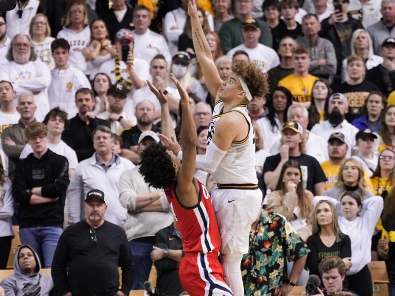 Mar 4, 2023; Columbia, Missouri, USA; Missouri Tigers forward Noah Carter (35) scores over Mississippi Rebels forward Jaemyn Brakefield (4) during the second half at Mizzou Arena. Mandatory Credit: Denny Medley-USA TODAY Sports