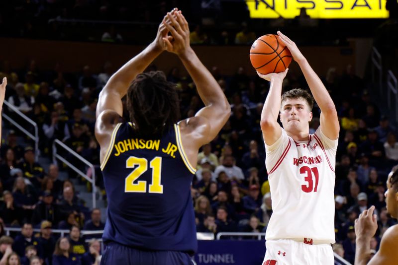 Jan 10, 2026; Ann Arbor, Michigan, USA;  Wisconsin Badgers forward Nolan Winter (31) shoots on Michigan Wolverines forward Morez Johnson Jr. (21) in the second half at Crisler Center. Mandatory Credit: Rick Osentoski-Imagn Images