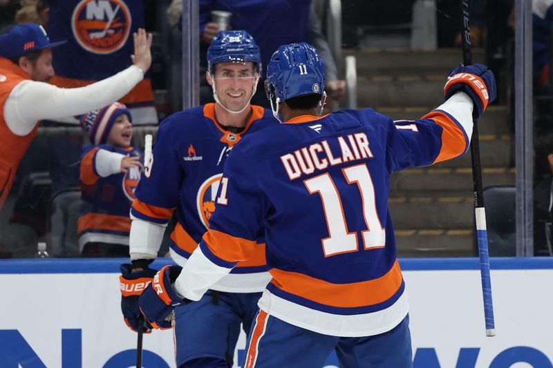 Jan 18, 2025; Elmont, New York, USA;  New York Islanders left wing Anthony Duclair (11) celebrates New York Islanders center Brock Nelson (29) goal against the San Jose Sharks during the second period at UBS Arena. Mandatory Credit: Thomas Salus-Imagn Images