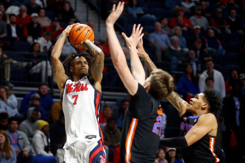 Jan 10, 2024; Oxford, Mississippi, USA; Mississippi Rebels guard Allen Flanigan (7) shoots over Florida Gators forward/center Alex Condon (21) and guard Will Richard (5) during the second half at The Sandy and John Black Pavilion at Ole Miss. Mandatory Credit: Petre Thomas-USA TODAY Sports