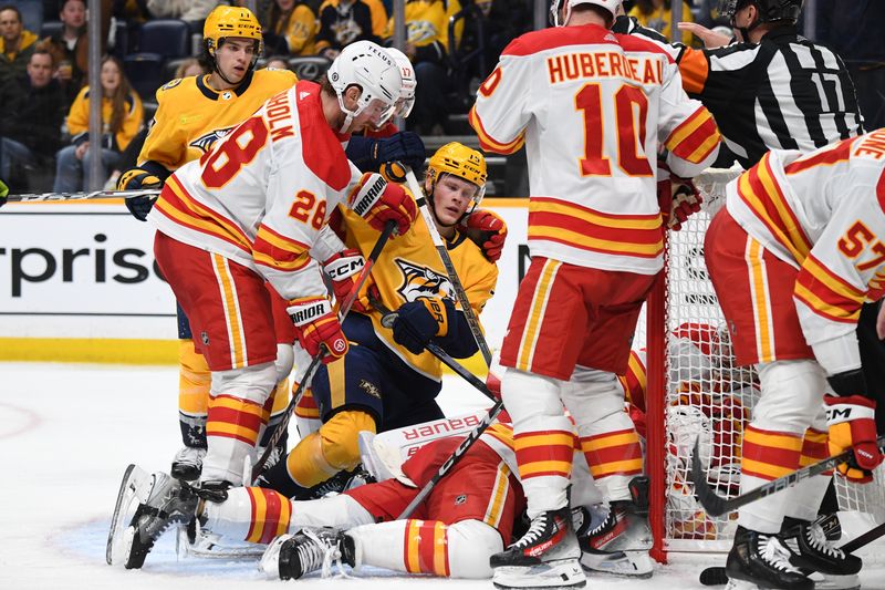 Jan 4, 2024; Nashville, Tennessee, USA; Nashville Predators center Juuso Parssinen (75) has a shot in the crease blocked by Calgary Flames players during the third period at Bridgestone Arena. Mandatory Credit: Christopher Hanewinckel-USA TODAY Sports