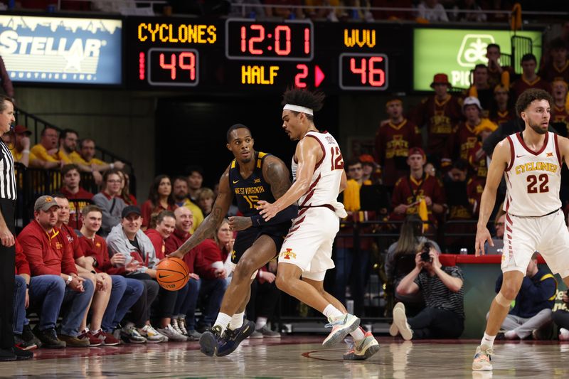 Feb 27, 2023; Ames, Iowa, USA; Iowa State Cyclones forward Robert Jones (12) defends West Virginia Mountaineers forward Jimmy Bell Jr. (15) during the second half at James H. Hilton Coliseum. Mandatory Credit: Reese Strickland-USA TODAY Sports