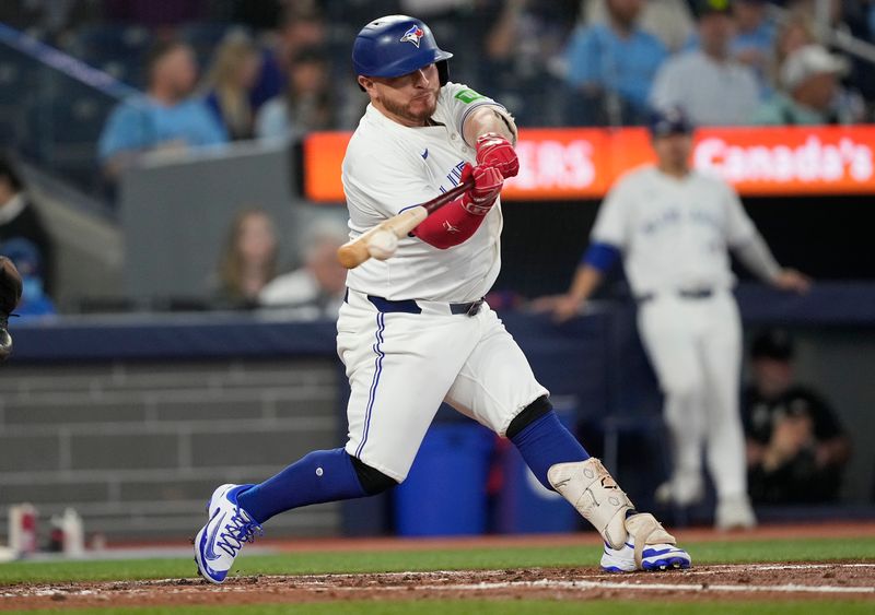 Jun 5, 2025; Toronto, Ontario, CAN; Toronto Blue Jays designated hitter Alejandro Kirk (30) hits a single against the Philadelphia Phillies during the third inning at Rogers Centre. Mandatory Credit: John E. Sokolowski-Imagn Images