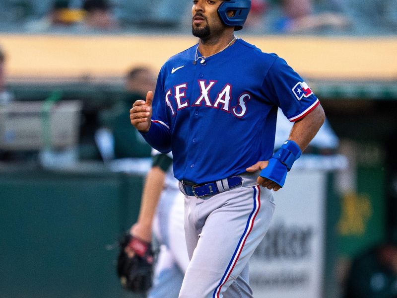 Aug 8, 2023; Oakland, California, USA;  Texas Rangers second baseman Marcus Semien (2) scores on a double by Texas Rangers shortstop Corey Seager (not pictured) against the Oakland Athletics during the fourth inning at Oakland-Alameda County Coliseum. Mandatory Credit: Neville E. Guard-USA TODAY Sports