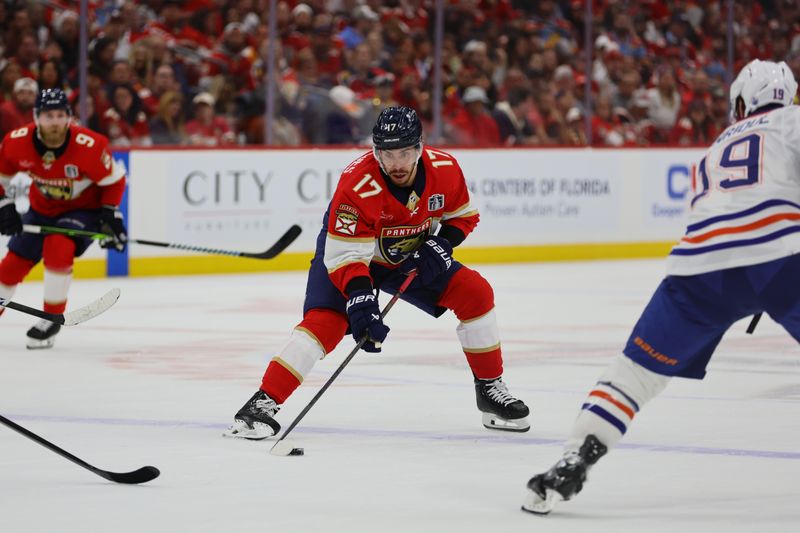Jun 10, 2024; Sunrise, Florida, USA; Florida Panthers forward Evan Rodrigues (17) skates with the puck against Edmonton Oilers forward Adam Henrique (19) during the second period in game two of the 2024 Stanley Cup Final at Amerant Bank Arena. Mandatory Credit: Sam Navarro-USA TODAY Sports