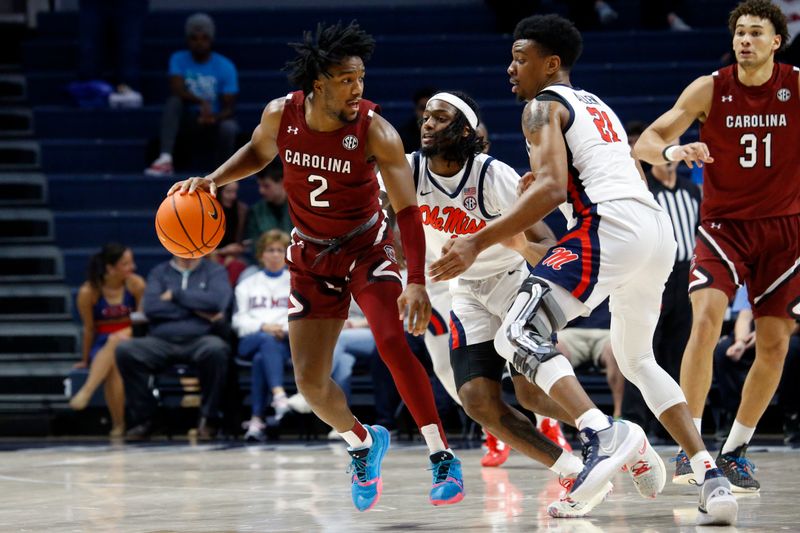 Feb 11, 2023; Oxford, Mississippi, USA; South Carolina Gamecocks guard Chico Carter Jr. (2) dribbles as Mississippi Rebels guard Amaree Abram (1) and forward Robert Allen (21) defend during the second half at The Sandy and John Black Pavilion at Ole Miss. Mandatory Credit: Petre Thomas-USA TODAY Sports