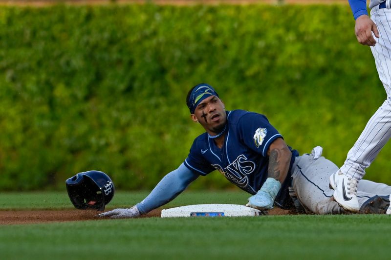 May 30, 2023; Chicago, Illinois, USA;  Tampa Bay Rays shortstop Wander Franco (5) loses his helmet while stealing second base against the Chicago Cubs during the first inning at Wrigley Field. Mandatory Credit: Matt Marton-USA TODAY Sports