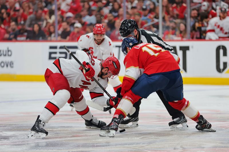 May 24, 2025; Sunrise, Florida, USA; Carolina Hurricanes center Jesperi Kotkaniemi (82) and Florida Panthers center Anton Lundell (15) face-off during the third period in game three of the Eastern Conference Final of the 2025 Stanley Cup Playoffs at Amerant Bank Arena. Mandatory Credit: Sam Navarro-Imagn Images