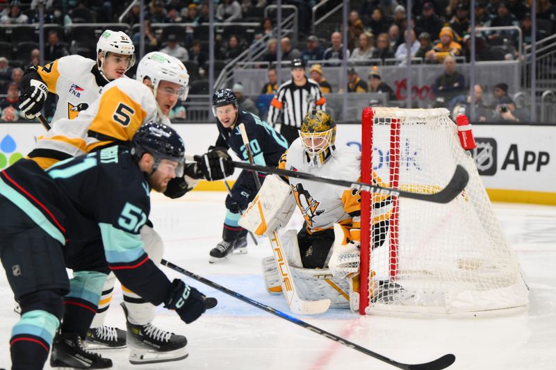 Jan 25, 2025; Seattle, Washington, USA; Pittsburgh Penguins goaltender Joel Blomqvist (30) defends the goal against the Seattle Kraken during the third period at Climate Pledge Arena. Mandatory Credit: Steven Bisig-Imagn Images