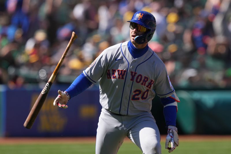 Apr 16, 2023; Oakland, California, USA; New York Mets first baseman Pete Alonso (20) flips his bat after hitting a home run against the Oakland Athletics during the ninth inning at RingCentral Coliseum. Mandatory Credit: Darren Yamashita-USA TODAY Sports