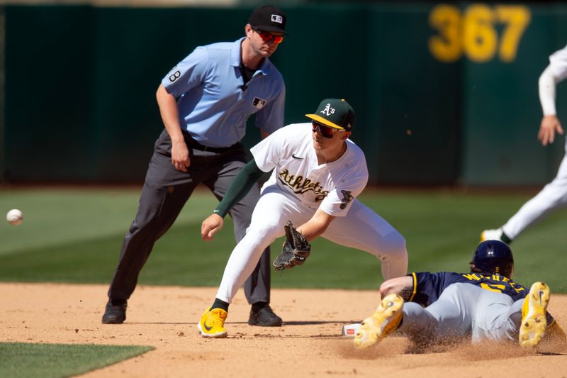 Aug 25, 2024; Oakland, California, USA; Oakland Athletics second baseman Zack Gelof (20) takes the throw from catcher in time to tag out Milwaukee Brewers pinch runner Garrett Mitchell (5) during the seventh inning at Oakland-Alameda County Coliseum. Mandatory Credit: D. Ross Cameron-USA TODAY Sports