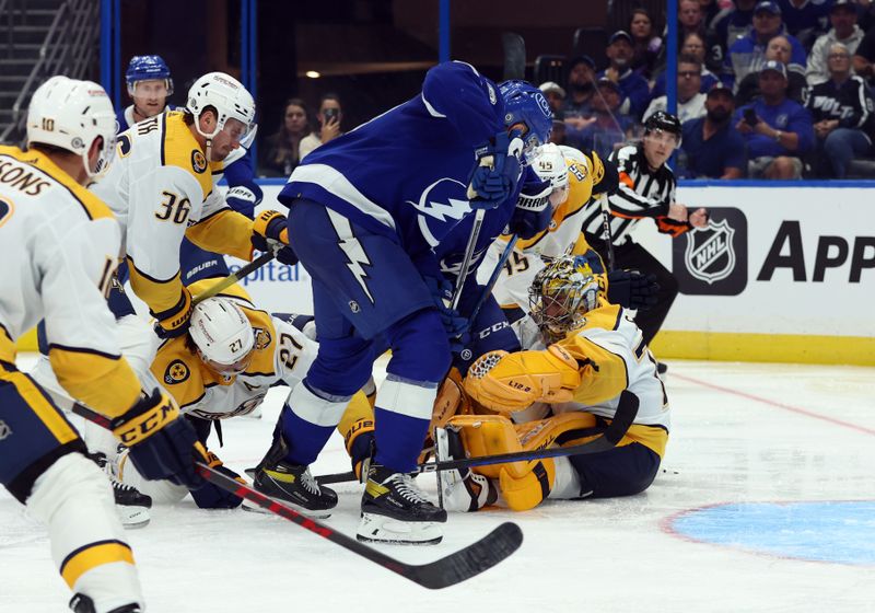 Oct 10, 2023; Tampa, Florida, USA; Tampa Bay Lightning left wing Nicholas Paul (20) scores a goal on Nashville Predators goaltender Juuse Saros (74)  during the third period at Amalie Arena. Mandatory Credit: Kim Klement Neitzel-USA TODAY Sports