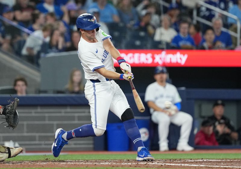 May 18, 2025; Toronto, Ontario, CAN;Toronto Blue Jays second baseman Ernie Clement (22) hits an RBI single against the Detroit Tigers during the fourth inning at Rogers Centre. Mandatory Credit: Nick Turchiaro-Imagn Images