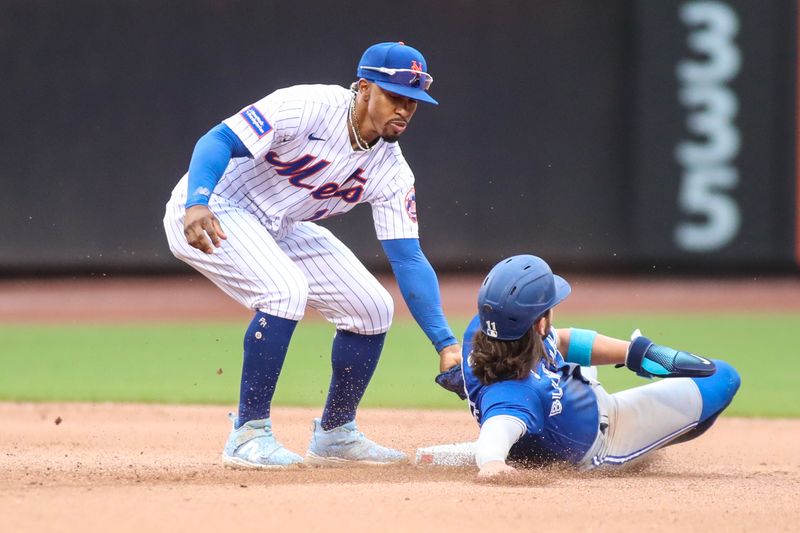 Jun 3, 2023; New York City, New York, USA;  New York Mets shortstop Francisco Lindor (12) tags out Toronto Blue Jays shortstop Bo Bichette (11) in the fifth inning at Citi Field. Mandatory Credit: Wendell Cruz-USA TODAY Sports