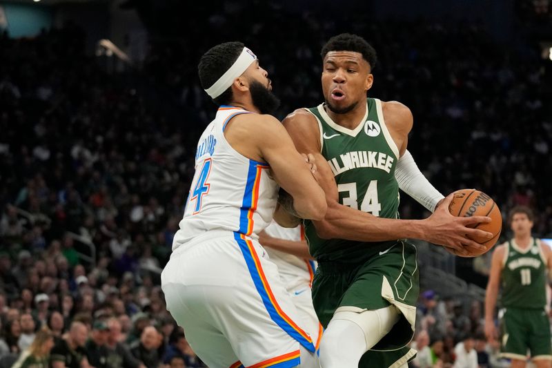 MILWAUKEE, WISCONSIN - MARCH 24: Giannis Antetokounmpo #34 of the Milwaukee Bucks drives against Kenrich Williams #34 of the Oklahoma City Thunder during the second half at Fiserv Forum on March 24, 2024 in Milwaukee, Wisconsin. NOTE TO USER: User expressly acknowledges and agrees that, by downloading and or using this photograph, User is consenting to the terms and conditions of the Getty Images License Agreement. (Photo by Patrick McDermott/Getty Images)