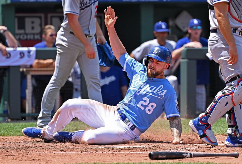 Jul 2, 2023; Kansas City, Missouri, USA;  Kansas City Royals center fielder Kyle Isbel (28) scores a run in the fourth inning against the Los Angeles Dodgers at Kauffman Stadium. Mandatory Credit: Peter Aiken-USA TODAY Sports