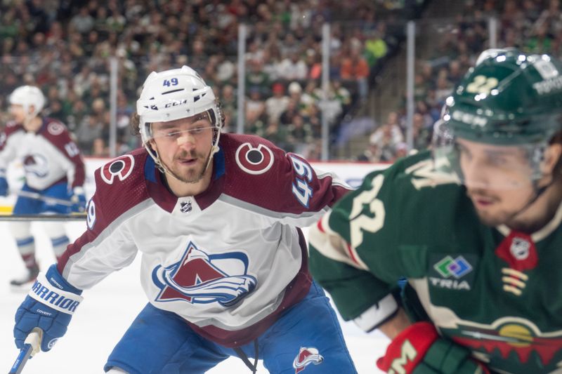 Apr 4, 2024; Saint Paul, Minnesota, USA; Colorado Avalanche defenseman Samuel Girard (49) checks Minnesota Wild center Marat Khusnutdinov (22) in the third period at Xcel Energy Center. Mandatory Credit: Matt Blewett-USA TODAY Sports