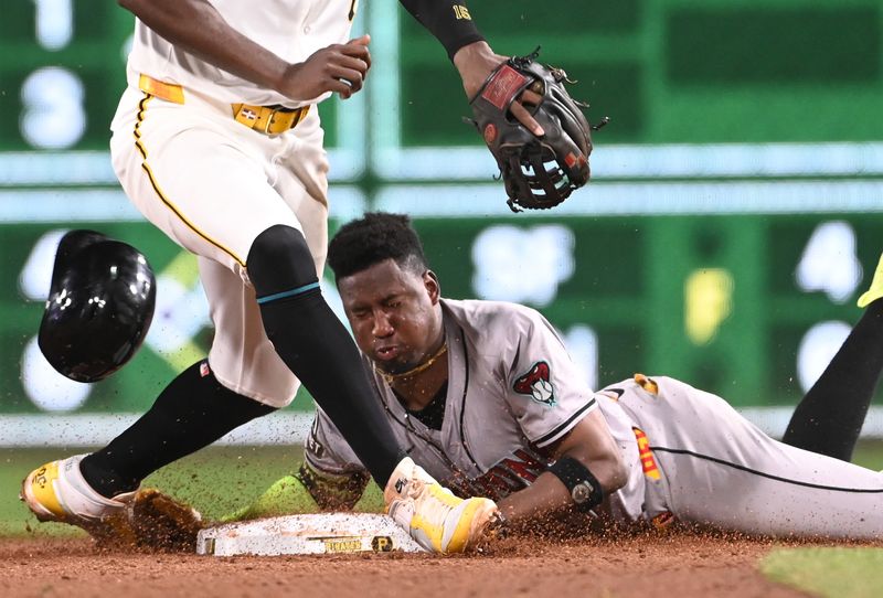 Aug 3, 2024; Pittsburgh, Pennsylvania, USA;  Arizona Diamondbacks base runner Geraldo Perdomo (2) makes it into second base for a double as Pittsburgh Pirates shortstop Oneil Cruz (15) handles the ball in the ninth inning at PNC Park. The Pirates won 4-2. Mandatory Credit: Philip G. Pavely-USA TODAY Sports