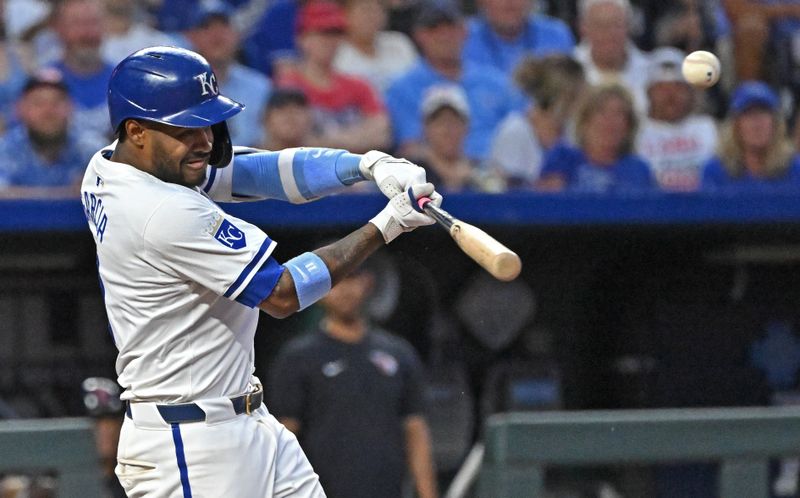 Jun 27, 2024; Kansas City, Missouri, USA;  Kansas City Royals second baseman Maikel Garcia (11) hits a RBI triple in the sixth inning against the Cleveland Guardians at Kauffman Stadium. Mandatory Credit: Peter Aiken-USA TODAY Sports