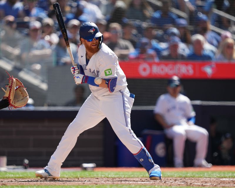 Jun 15, 2024; Toronto, Ontario, CAN; Toronto Blue Jays designated hitter Justin Turner (2) gets hit with a pitch against the Cleveland Guardians during the fifth inning at Rogers Centre. Mandatory Credit: Nick Turchiaro-USA TODAY Sports