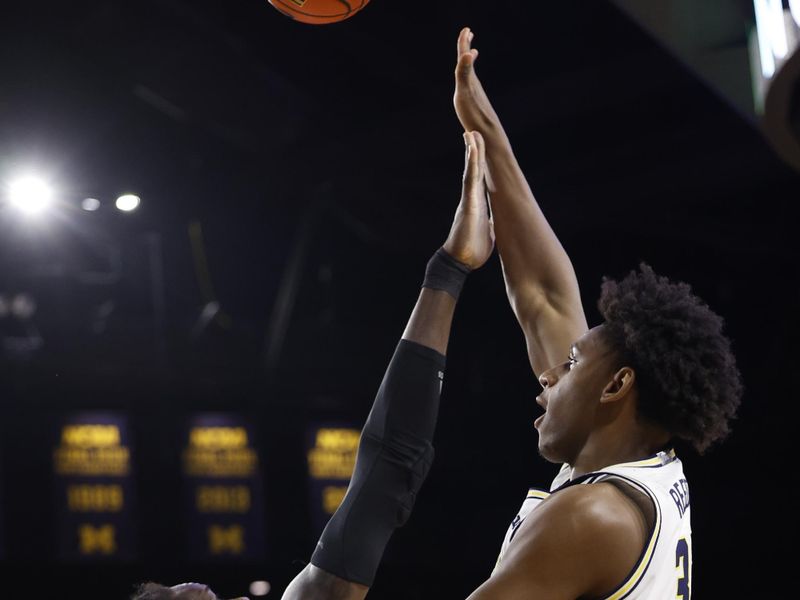 Feb 3, 2024; Ann Arbor, Michigan, USA;  Michigan Wolverines forward Tarris Reed Jr. (32) shoots on Rutgers Scarlet Knights center Clifford Omoruyi (11) in the first half at Crisler Center. Mandatory Credit: Rick Osentoski-USA TODAY Sports