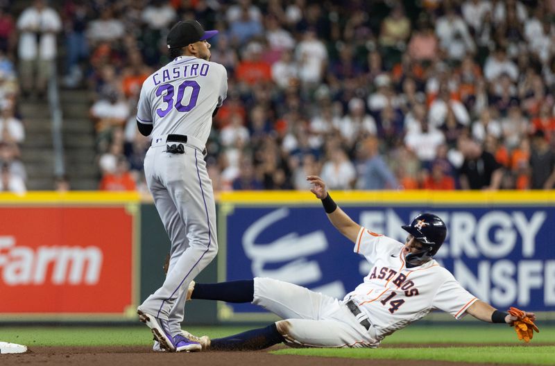 Jul 5, 2023; Houston, Texas, USA; Colorado Rockies second baseman Harold Castro (30) forces Houston Astros second baseman Mauricio Dubon (14) out at second base and turns a double play in the first inning at Minute Maid Park. Mandatory Credit: Thomas Shea-USA TODAY Sports