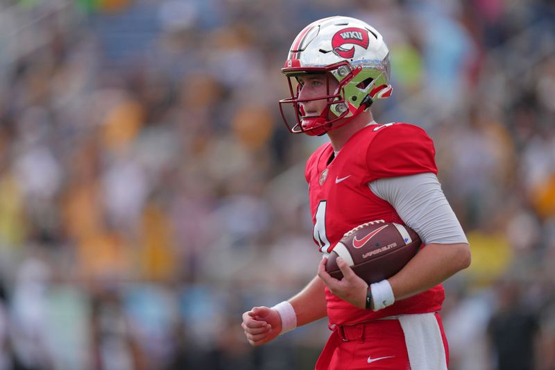 Dec 18, 2021; Boca Raton, Florida, USA; Western Kentucky Hilltoppers quarterback Bailey Zappe (4) runs off the field with the ball that was thrown to break the FBS all time single season touchdown record during the second half against the Appalachian State Mountaineers in the 2021 Boca Raton Bowl at FAU Stadium. Mandatory Credit: Jasen Vinlove-USA TODAY Sports