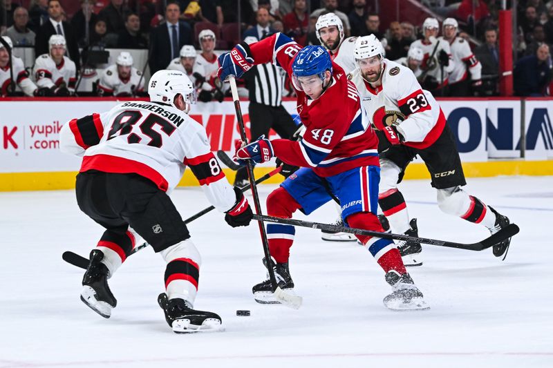 Oct 4, 2025; Montreal, Quebec, CAN; Montreal Canadiens defenseman Lane Hutson (48) plays the puck against Ottawa Senators defenseman Jake Sanderson (85) during the first period at Bell Centre. Mandatory Credit: David Kirouac-Imagn Images