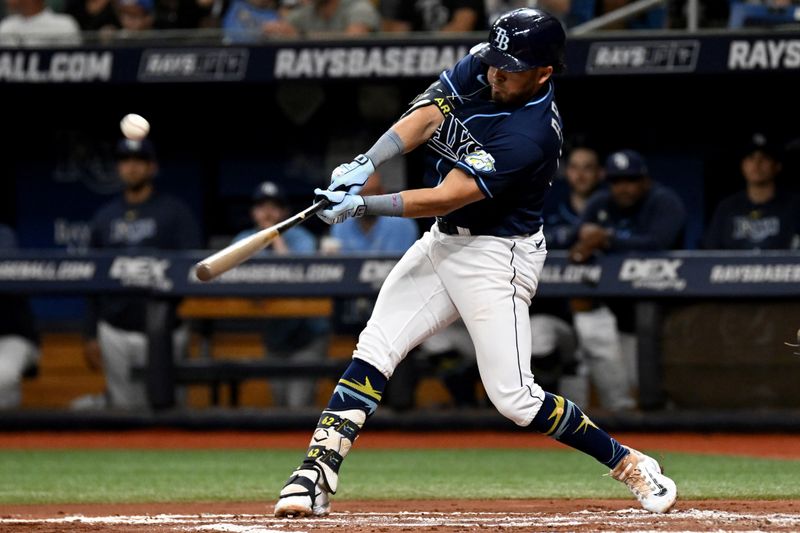 Aug 26, 2023; St. Petersburg, Florida, USA; Tampa Bay Rays first baseman Jonathan Aranda (62) hits a sacrifice fly ball against the New York Yankees in the second inning at Tropicana Field. Mandatory Credit: Jonathan Dyer-USA TODAY Sports