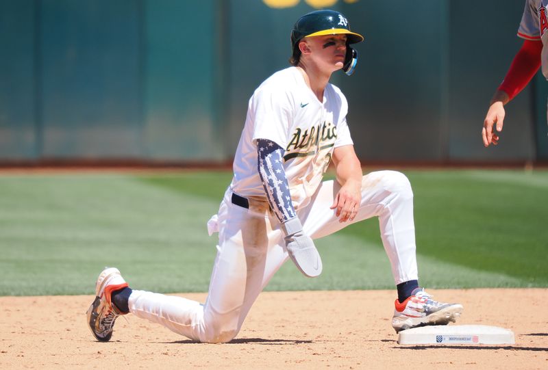 Jul 4, 2024; Oakland, California, USA; Oakland Athletics second baseman Zack Gelof (20) safe at second base against the Los Angeles Angels during the sixth inning at Oakland-Alameda County Coliseum. Mandatory Credit: Kelley L Cox-USA TODAY Sports