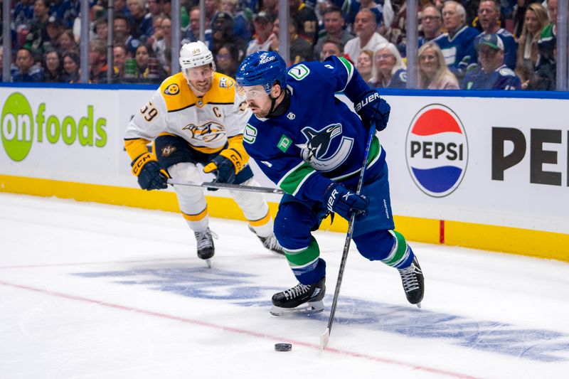 Apr 21, 2024; Vancouver, British Columbia, CAN; Nashville Predators defenseman Roman Josi (59) watches Vancouver Canucks forward Conor Garland (8) handle the puck in the third period in game one of the first round of the 2024 Stanley Cup Playoffs at Rogers Arena.  Mandatory Credit: Bob Frid-USA TODAY Sports