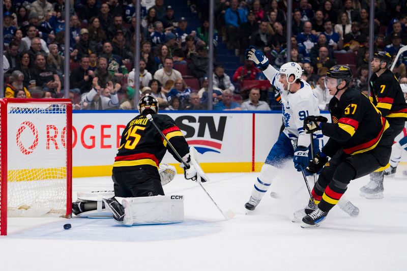 Jan 20, 2024; Vancouver, British Columbia, CAN; Vancouver Canucks goalie Thatcher Demko (35) and defenseman Tyler Myers (57) react as Toronto Maple Leafs forward John Tavares (91) celebrates a goal in the second period at Rogers Arena. Mandatory Credit: Bob Frid-USA TODAY Sports