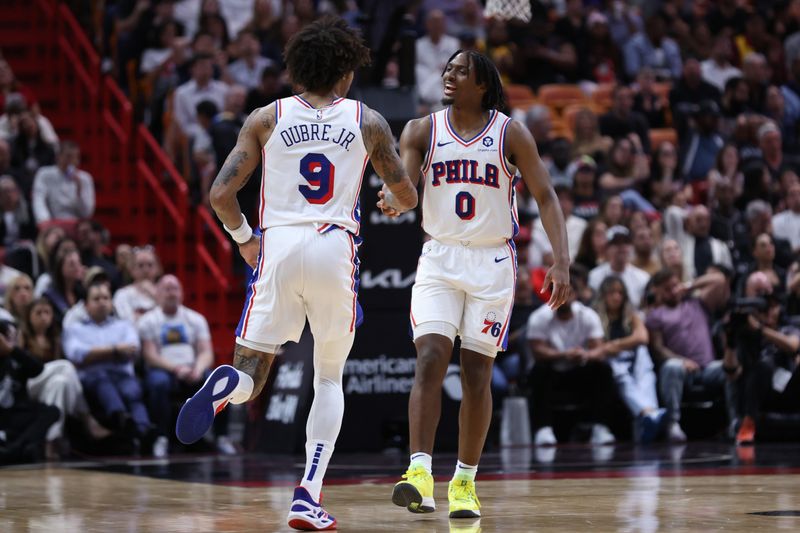 MIAMI, FLORIDA - APRIL 04: Kelly Oubre Jr. #9 and Tyrese Maxey #0 of the Philadelphia 76ers react during the fourth quarter of the game against the Miami Heat at Kaseya Center on April 04, 2024 in Miami, Florida. NOTE TO USER: User expressly acknowledges and agrees that, by downloading and or using this photograph, User is consenting to the terms and conditions of the Getty Images License Agreement. (Photo by Megan Briggs/Getty Images)