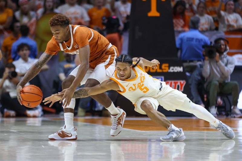 Jan 28, 2023; Knoxville, Tennessee, USA; Texas Longhorns guard Arterio Morris (2) and Tennessee Volunteers guard Zakai Zeigler (5) fight for a loose ball during the second half at Thompson-Boling Arena. Mandatory Credit: Randy Sartin-USA TODAY Sports