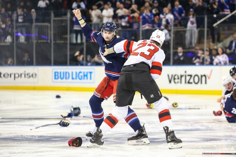 Apr 3, 2024; New York, New York, USA; New York Rangers center Matt Rempe (73) and New Jersey Devils defenseman Kurtis MacDermid (23) fight at start of the 1st period at Madison Square Garden. Mandatory Credit: Wendell Cruz-USA TODAY Sports