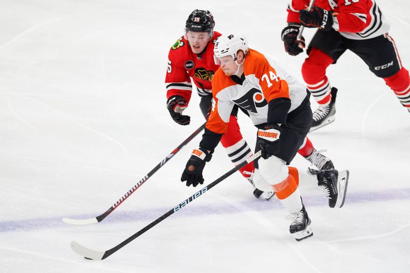 Feb 21, 2024; Chicago, Illinois, USA; Chicago Blackhawks right wing Joey Anderson (15) defends against Philadelphia Flyers right wing Owen Tippett (74) during the second period at United Center. Mandatory Credit: Kamil Krzaczynski-USA TODAY Sports