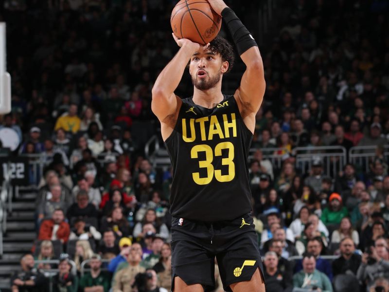 MILWAUKEE, WI - NOVEMBER 7: Johnny Juzang #33 of the Utah Jazz shoots a three point basket during the game against the Milwaukee Bucks on November 7, 2024 at Fiserv Forum Center in Milwaukee, Wisconsin. NOTE TO USER: User expressly acknowledges and agrees that, by downloading and or using this Photograph, user is consenting to the terms and conditions of the Getty Images License Agreement. Mandatory Copyright Notice: Copyright 2024 NBAE (Photo by Gary Dineen/NBAE via Getty Images).