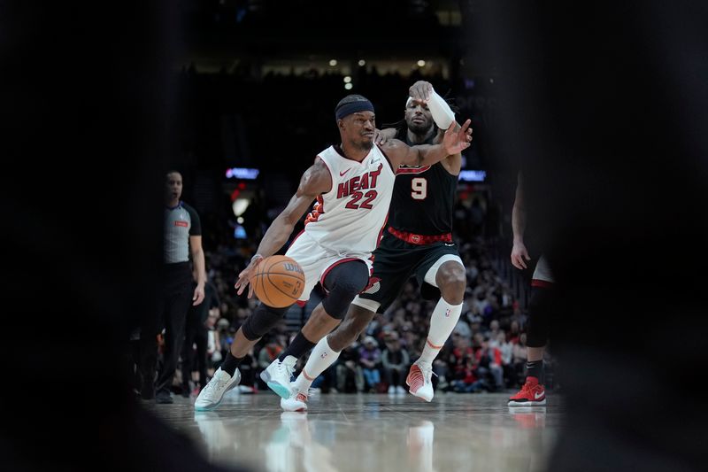 PORTLAND, OREGON - FEBRUARY 27: Jimmy Butler #22 of the Miami Heat dribbles the ball while defended by Jerami Grant #9 of the Portland Trail Blazers during the second half at Moda Center on February 27, 2024 in Portland, Oregon. NOTE TO USER: User expressly acknowledges and agrees that, by downloading and or using this photograph, User is consenting to the terms and conditions of the Getty Images License Agreement. (Photo by Soobum Im/Getty Images)